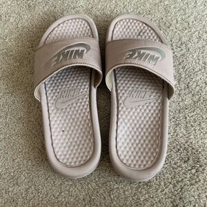 Women rose gold Nike slides